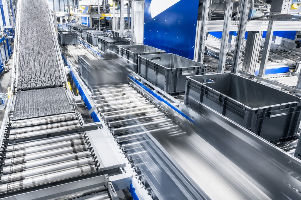 Automated conveyor lines moving crates inside a commercial facility